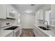Stylish kitchen with white cabinetry, quartz countertops and stainless appliances, all newly updated at 9403 N 13Th St, Tampa, FL 33612