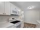 Modern kitchen with updated appliances, white quartz countertops and sleek cabinetry at 9403 N 13Th St, Tampa, FL 33612