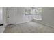 Bright living room featuring carpet and natural light from the two windows at 9403 N 13Th St, Tampa, FL 33612