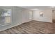 A living room is bright with hardwood floors, multiple windows and a pass-through to the kitchen at 9403 N 13Th St, Tampa, FL 33612