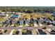 An aerial view of new neighborhood showcasing neatly arranged homes, green space, and well-paved streets at 10940 Trailing Vine Dr, Tampa, FL 33610