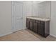 Bathroom features a double sink vanity with dark cabinets and neutral countertops at 10940 Trailing Vine Dr, Tampa, FL 33610