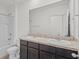 Bathroom with double sinks, dark wood cabinets, a full mirror, and a shower/tub combo at 10940 Trailing Vine Dr, Tampa, FL 33610