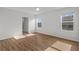 Spacious bedroom with hardwood floors and two windows letting in plenty of natural light at 10940 Trailing Vine Dr, Tampa, FL 33610