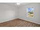 Bright bedroom featuring hardwood floors, a ceiling fan, and a window with a view of the outdoors at 10940 Trailing Vine Dr, Tampa, FL 33610
