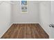 Spacious closet featuring wood-look flooring, a window for natural light, and white shelving at 10940 Trailing Vine Dr, Tampa, FL 33610