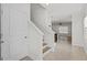 Bright entryway showcasing tile flooring, stairs, and a glimpse into the living area at 10940 Trailing Vine Dr, Tampa, FL 33610