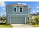 Stylish two-story home boasts a neatly landscaped front yard and a spacious driveway at 10940 Trailing Vine Dr, Tampa, FL 33610