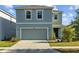 Charming two-story home features a well-manicured lawn and a two-car garage at 10940 Trailing Vine Dr, Tampa, FL 33610