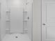 Bright shower with white tiling and a built-in shower seat at 10940 Trailing Vine Dr, Tampa, FL 33610