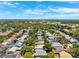 Aerial view showcasing a residential area with mature trees, manicured lawns, and community amenities at 1118 Captains Way, Tarpon Springs, FL 34689