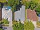 Aerial view of a home showcasing the roof, nearby swimming pool, and surrounding landscaping at 1118 Captains Way, Tarpon Springs, FL 34689