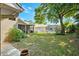 Spacious backyard featuring a large grassy area, patio area and a pool at 1118 Captains Way, Tarpon Springs, FL 34689