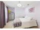 Cozy bedroom featuring plush carpet, closet, and natural light from a large window at 1118 Captains Way, Tarpon Springs, FL 34689