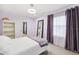 Light purple bedroom with plush carpet, closet, and natural light from a large window at 1118 Captains Way, Tarpon Springs, FL 34689
