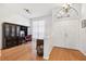 Inviting foyer area with a large arched doorway, hardwood floors, and a built-in desk area at 1118 Captains Way, Tarpon Springs, FL 34689