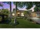 Charming single-story home featuring lush landscaping, a two-car garage, and a covered front entry at 1118 Captains Way, Tarpon Springs, FL 34689