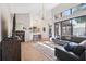 Bright living room with an open layout, statement chandelier, and adjacent breakfast bar at 1118 Captains Way, Tarpon Springs, FL 34689