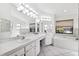 Bright bathroom with double sinks, soaking tub, and a bank of clerestory windows at 1118 Captains Way, Tarpon Springs, FL 34689