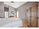 Spacious main bedroom featuring an armoire, warm wood floors, and vaulted ceilings at 1118 Captains Way, Tarpon Springs, FL 34689