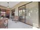Covered patio featuring an outdoor dining table, seating and view of the living area at 1118 Captains Way, Tarpon Springs, FL 34689