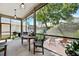 View of the screened patio featuring outdoor dining table, seating and a grill at 1118 Captains Way, Tarpon Springs, FL 34689