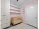 This cozy Bedroom features a crib, dark wood flooring, and floating shelves for storage and display at 1120 E Kennedy Blvd # 1228, Tampa, FL 33602
