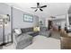Comfortable living area with a large sectional couch, ceiling fan, and adjacent kitchen area at 1120 E Kennedy Blvd # 1228, Tampa, FL 33602