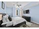 This spacious bedroom features a ceiling fan, a large window, and a dresser with a television on top at 1120 E Kennedy Blvd # 1228, Tampa, FL 33602