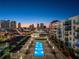 Rooftop pool with city skyline views at dusk at 1120 E Kennedy Blvd # 1228, Tampa, FL 33602