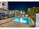 Relaxing pool at night with lounge chairs and lush greenery surrounding the pool deck at 1120 E Kennedy Blvd # 1228, Tampa, FL 33602
