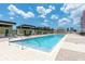 This community swimming pool has many chairs and loungers around it, with a view of the cityscape in the background at 1120 E Kennedy Blvd # 1228, Tampa, FL 33602