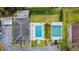 Overhead view of the pool and shuffleboard court featuring manicured lawns at 11200 102Nd Ave # 48, Seminole, FL 33778