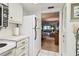 Kitchen with white refrigerator, white cabinets, and doorway to living room at 11200 102Nd Ave # 48, Seminole, FL 33778