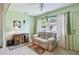 Bright living room features natural light, a writing desk, and casual sofa at 11200 102Nd Ave # 48, Seminole, FL 33778