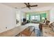 Bright living room with large window, ceiling fan, and comfortable seating area at 11200 102Nd Ave # 48, Seminole, FL 33778
