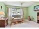The living room has green walls, big window, and decorative curtains at 11200 102Nd Ave # 48, Seminole, FL 33778