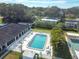 Aerial view of a community pool surrounded by lush landscaping and comfortable lounge chairs at 11200 102Nd Ave # 48, Seminole, FL 33778