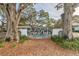 Twin Oaks entrance sign framed by mature trees with lush landscaping at 11200 102Nd Ave # 48, Seminole, FL 33778