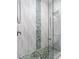 Beautiful bathroom featuring a tiled shower with a unique river rock floor and accent stripe at 11485 Oakhurst Rd # 312, Largo, FL 33774