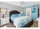 Well lit bedroom with ceiling fan, large bed with decor, and two side tables at 11485 Oakhurst Rd # 312, Largo, FL 33774