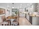Bright, updated kitchen with white cabinets, granite countertops, a stylish island, and stainless steel appliances at 11485 Oakhurst Rd # 312, Largo, FL 33774