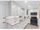 Well-lit kitchen with white cabinets, granite counters, stainless steel appliances, and modern fixtures at 11485 Oakhurst Rd # 312, Largo, FL 33774