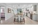 Bright, updated kitchen with white cabinets, granite countertops, a stylish island, and stainless steel appliances at 11485 Oakhurst Rd # 312, Largo, FL 33774