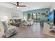 Inviting living room featuring stylish furnishings, tile flooring, and sliding glass doors to lanai at 11485 Oakhurst Rd # 312, Largo, FL 33774