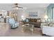 Comfortable living room with ceiling fan, neutral colors, artwork and comfortable seating arrangement at 11485 Oakhurst Rd # 312, Largo, FL 33774