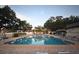Large community swimming pool with blue water, surrounded by lounge chairs and lush trees at 11485 Oakhurst Rd # 312, Largo, FL 33774