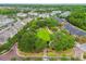Aerial scene showcasing community green spaces, walkways, and a variety of residences with lush trees at 11541 Fountainhead Dr, Tampa, FL 33626