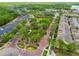 Captivating aerial perspective of a community featuring lush green spaces, winding brick-paved roads, and meticulously landscaped gardens at 11541 Fountainhead Dr, Tampa, FL 33626
