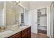 Well-lit bathroom with granite counters, double sinks, glass shower, and closet at 11541 Fountainhead Dr, Tampa, FL 33626